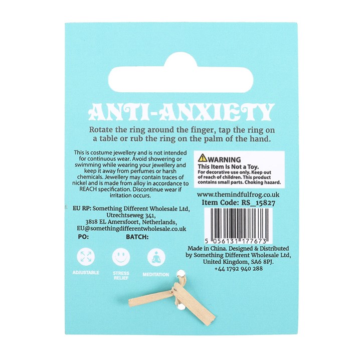 Back of an anti-anxiety ring packaging with text and a warning label on a light blue background.