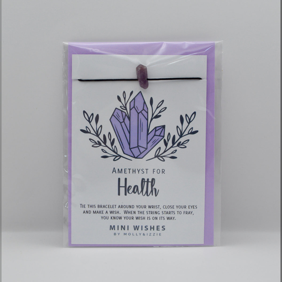 A packaged amethyst bracelet with a lavender and white card featuring crystal artwork and the text 'Amethyst for Health'. Comes with a purple envelope. 