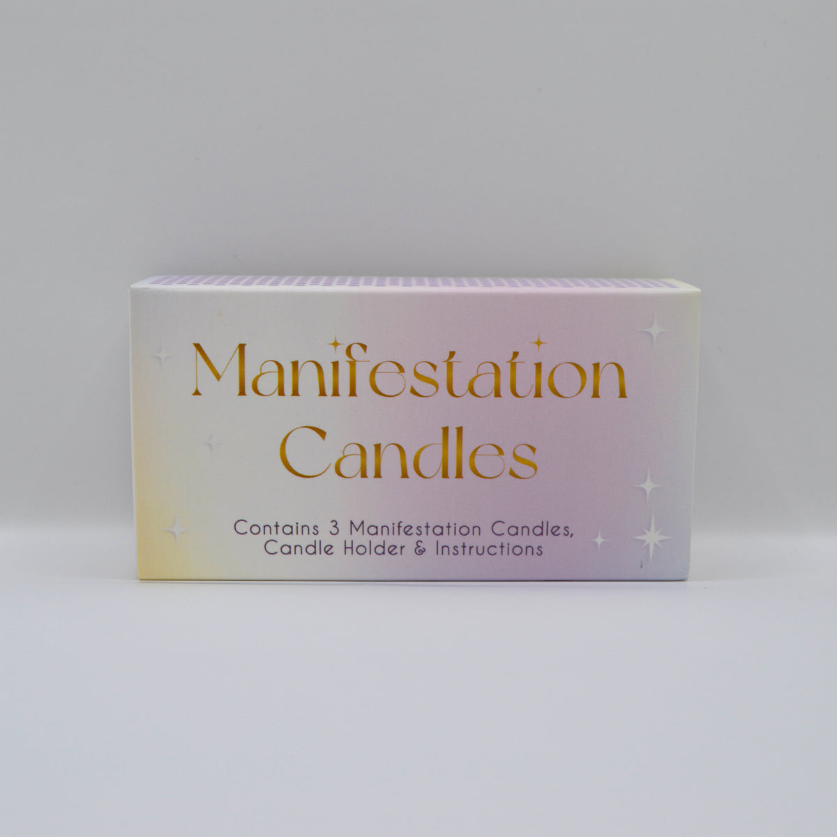 A rectangular product box for 'Manifestation Candles' with a soft pastel gradient background transitioning from pale yellow to lavender and light blue, featuring gold and black text.